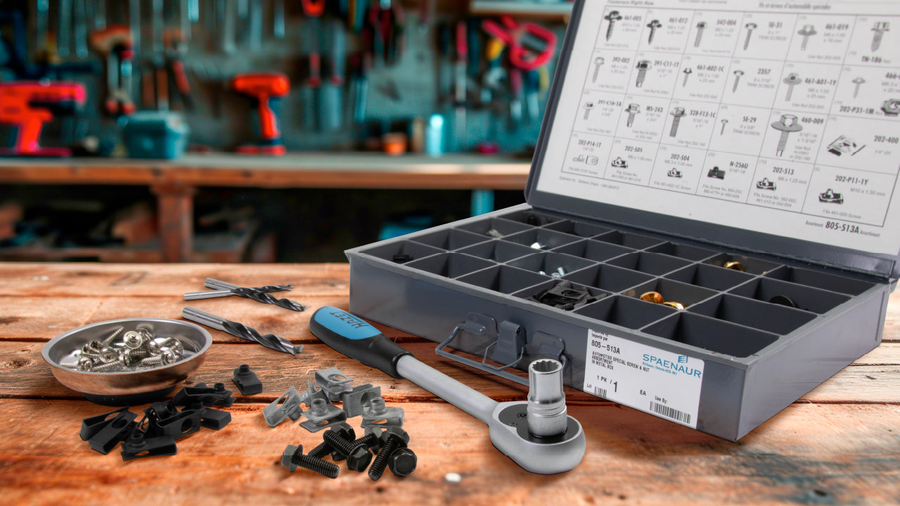 An assortment of automotive parts and tools on a workbench.